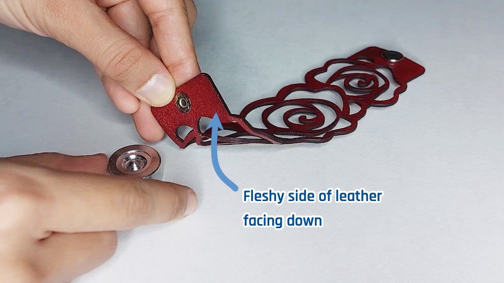 Correct placement of eyelet Place eyelet up through the remaining hole with the flat part facing the fleshy side of the leather